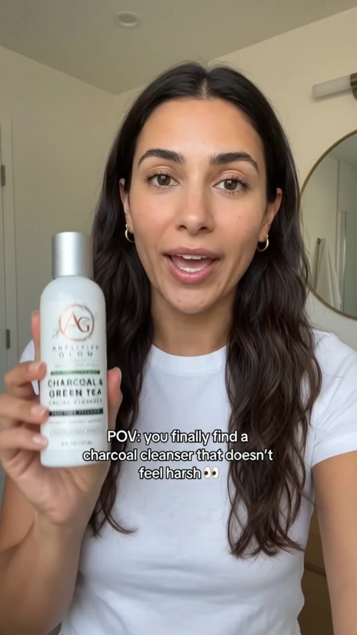 Creator presenting Amplified Glow charcoal and green tea facial cleanser in an AI UGC video